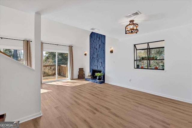 unfurnished living room featuring a fireplace and light hardwood / wood-style flooring