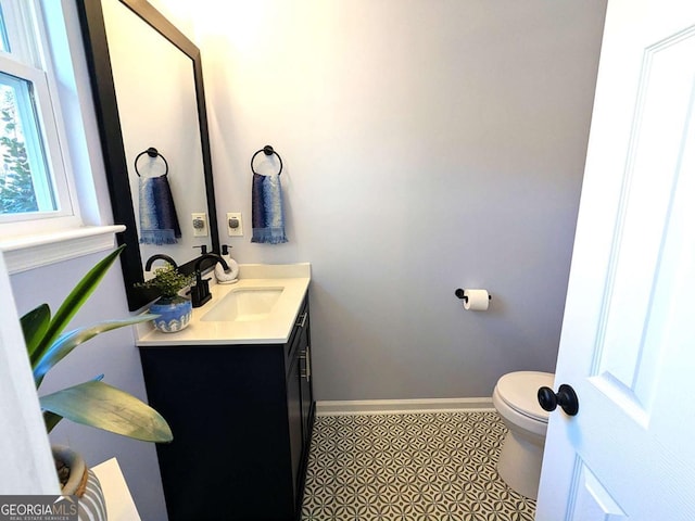 bathroom featuring vanity and toilet