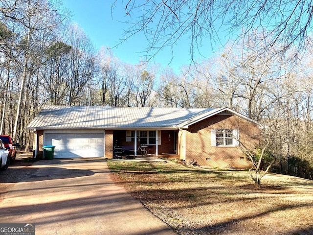 single story home with a porch and a garage