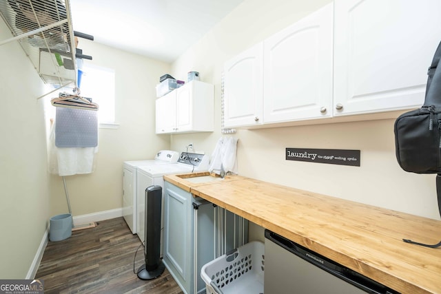 laundry area with cabinets, dark hardwood / wood-style floors, and washer and dryer