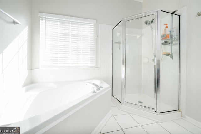 bathroom featuring tile patterned flooring and shower with separate bathtub