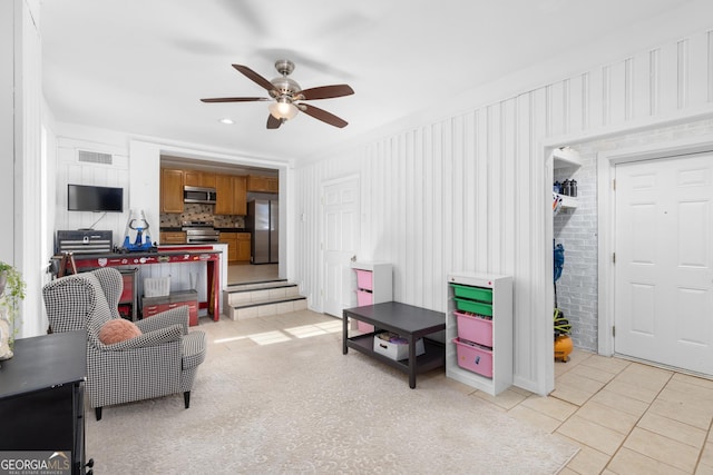 tiled living room featuring ceiling fan