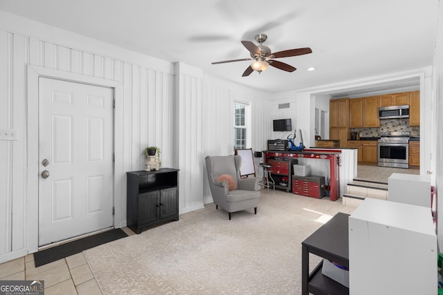 tiled living room with ceiling fan