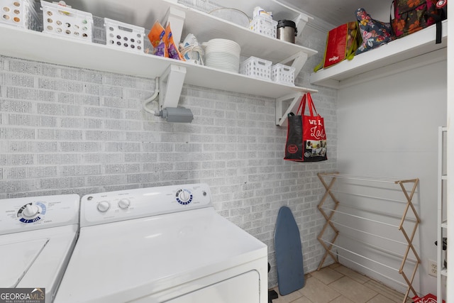 washroom with separate washer and dryer and light tile patterned floors