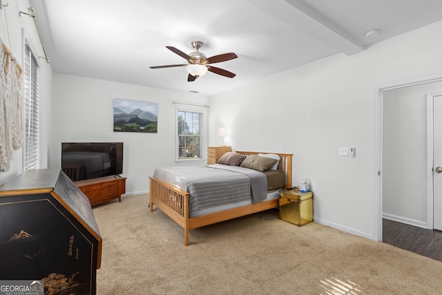 bedroom featuring ceiling fan, carpet floors, and beam ceiling