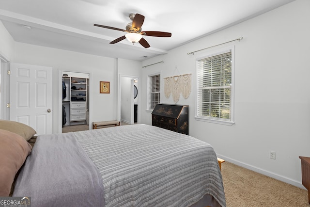 carpeted bedroom featuring a spacious closet, ceiling fan, and a closet