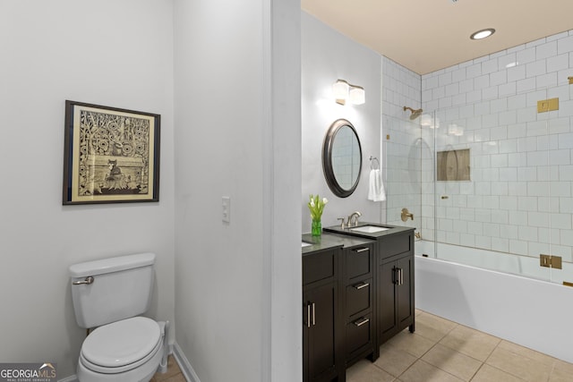 full bathroom with tile patterned flooring, vanity, tiled shower / bath combo, and toilet