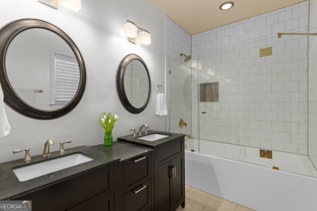 bathroom featuring tiled shower / bath, vanity, and tile patterned flooring