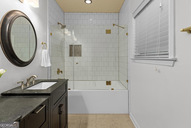 bathroom with tile patterned flooring, tiled shower / bath, and vanity