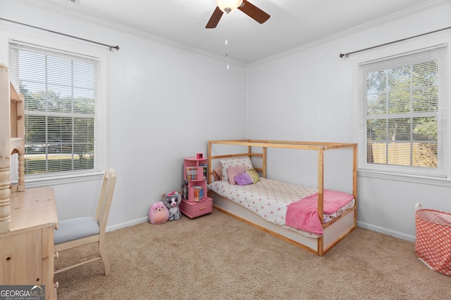 carpeted bedroom with ornamental molding and ceiling fan