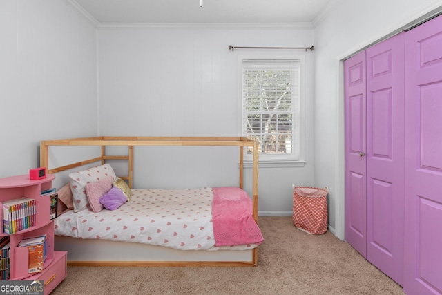 bedroom featuring crown molding, a closet, and light carpet