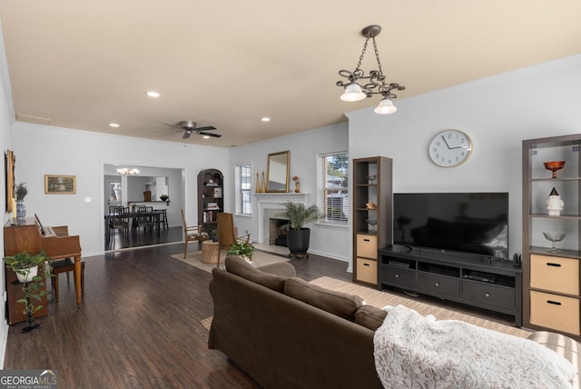 living room featuring dark hardwood / wood-style floors and ceiling fan