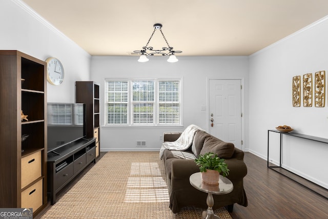 living room with hardwood / wood-style floors and ornamental molding