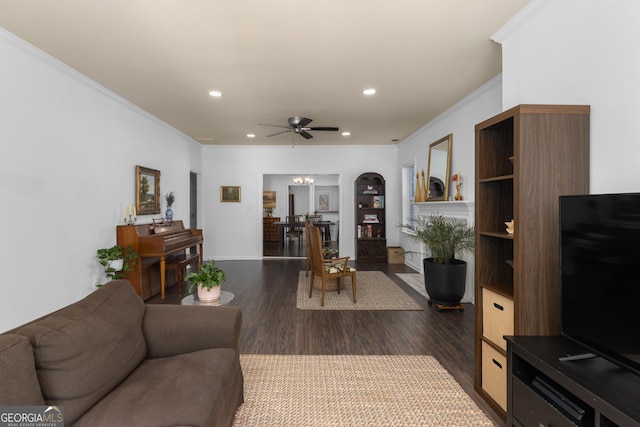 living room featuring crown molding, ceiling fan, and dark hardwood / wood-style flooring