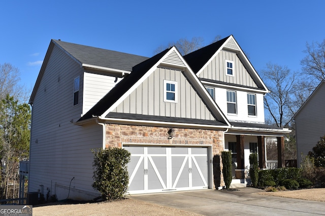 view of front of house with cooling unit, a porch, and a garage