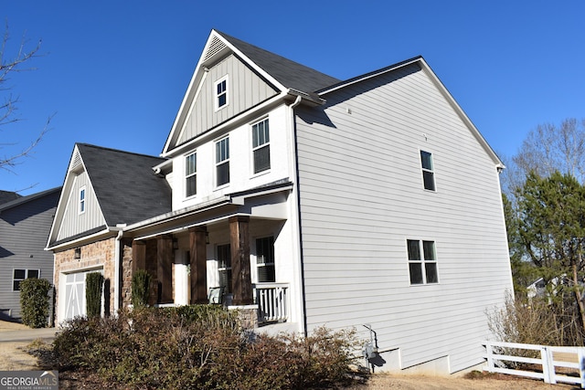 view of home's exterior with a garage and covered porch