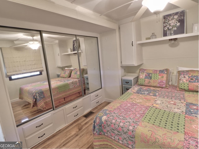 bedroom with light wood-style flooring and a closet