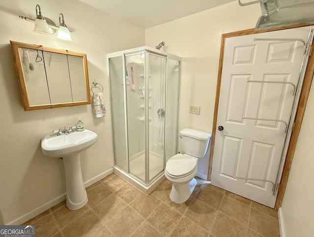 170 Tip Top Cir, Cleveland, GA 30528 - bathroom featuring a stall shower, toilet, a sink, and baseboards