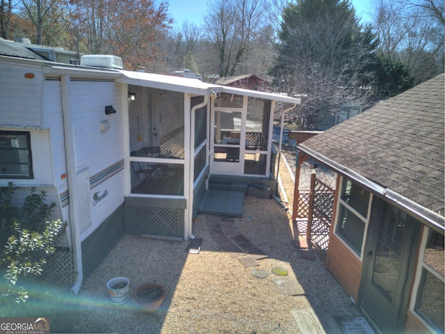 view of side of property featuring a sunroom