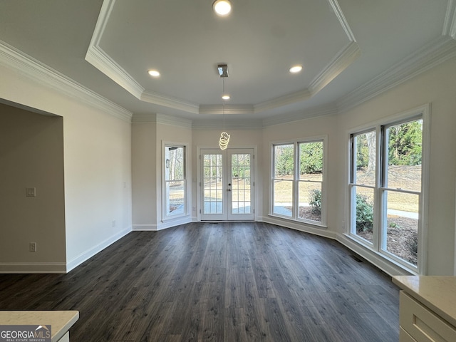 unfurnished room with a raised ceiling, crown molding, dark hardwood / wood-style floors, and french doors