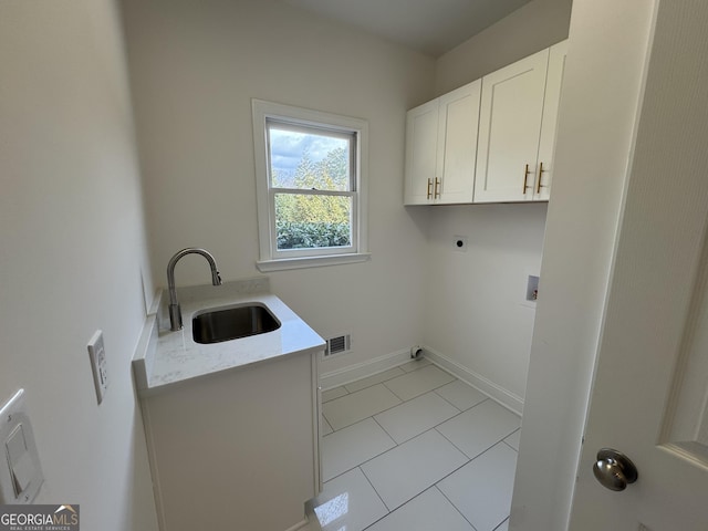 washroom with sink, cabinets, washer hookup, light tile patterned floors, and hookup for an electric dryer