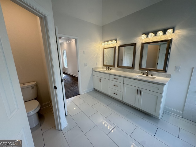 bathroom with vanity, tile patterned flooring, and toilet