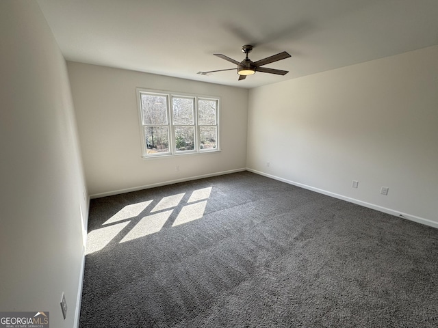 unfurnished room with ceiling fan and dark colored carpet