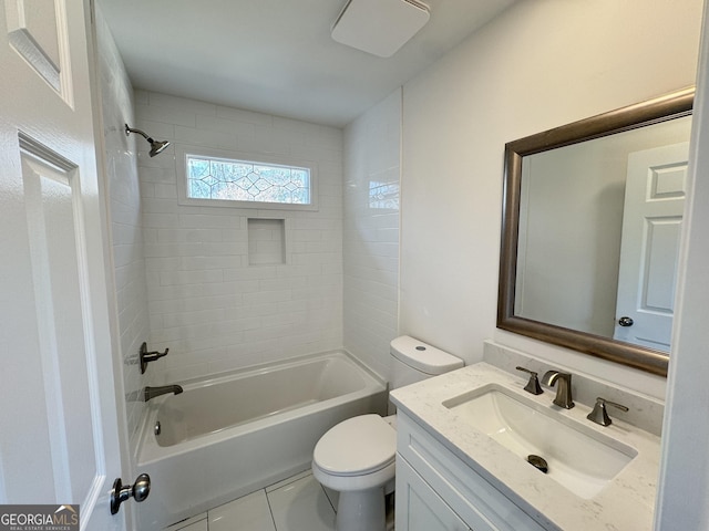 full bathroom featuring tile patterned floors, vanity, toilet, and tiled shower / bath combo