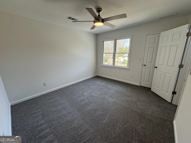 unfurnished bedroom featuring ceiling fan and dark colored carpet