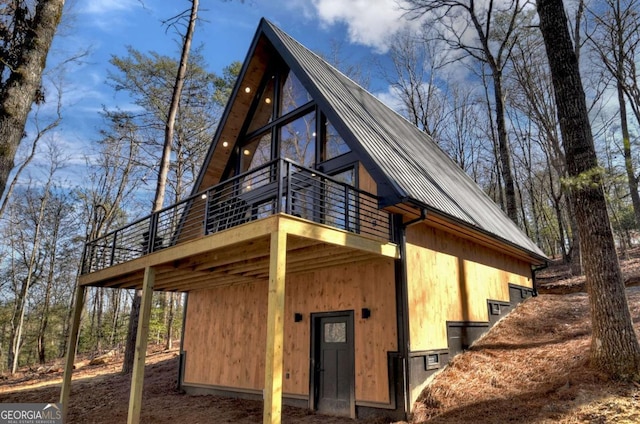 exterior space featuring metal roof and a deck