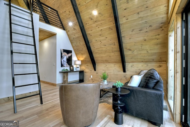 sitting room with wood finished floors, baseboards, high vaulted ceiling, beam ceiling, and wooden ceiling