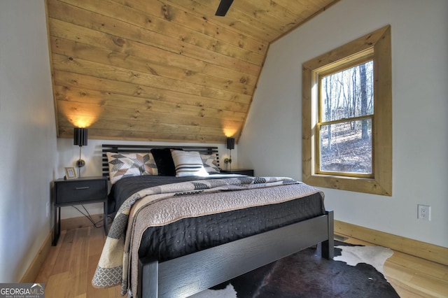 bedroom featuring wooden ceiling, baseboards, lofted ceiling, and wood finished floors