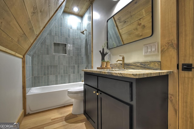 bathroom featuring wood ceiling, shower / tub combination, toilet, wood finished floors, and vanity