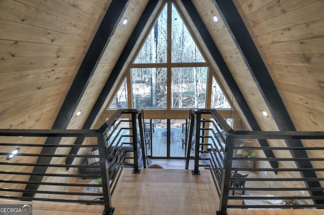 stairs featuring beam ceiling and wood ceiling