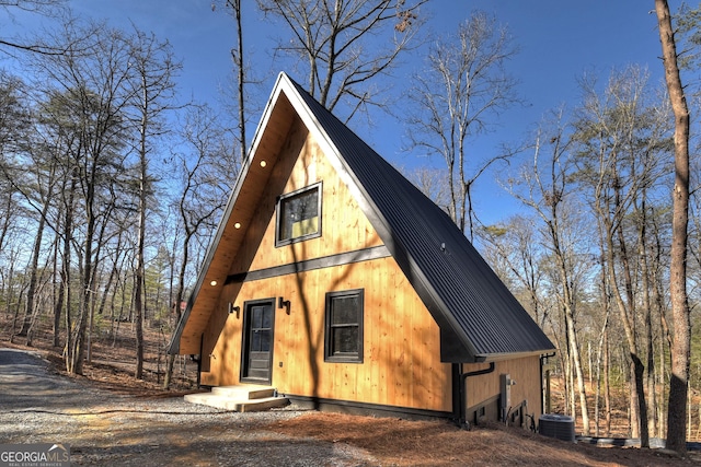 a-frame style home featuring central AC unit and metal roof