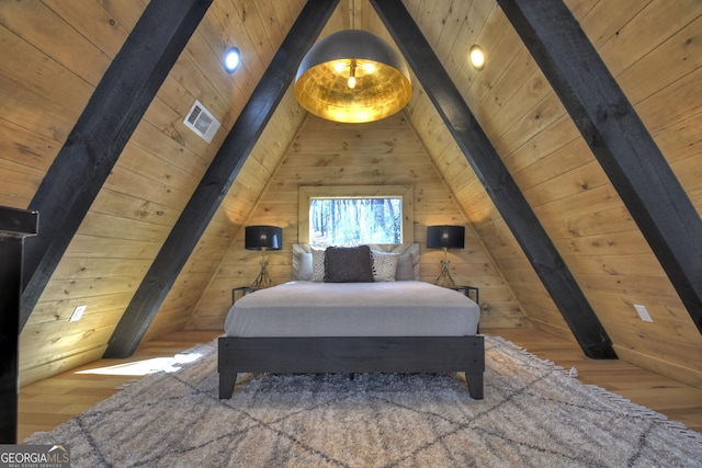 bedroom featuring visible vents, lofted ceiling with beams, wood finished floors, wooden walls, and wood ceiling