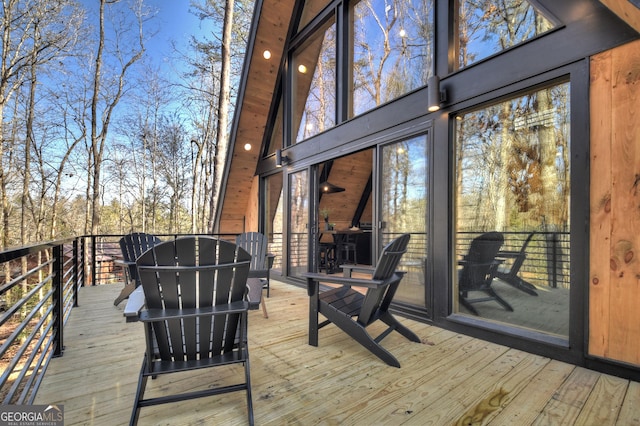 wooden terrace with outdoor dining area