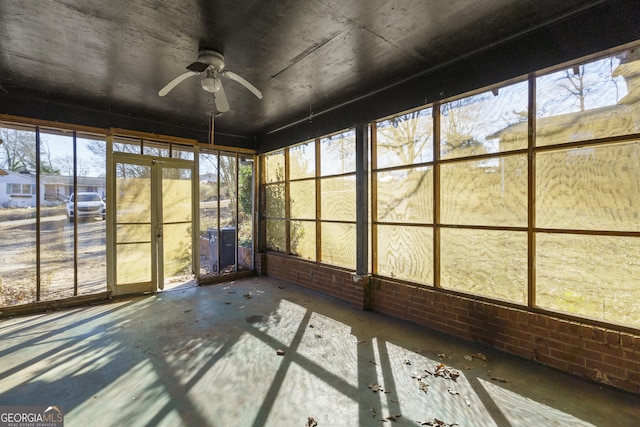 unfurnished sunroom featuring ceiling fan