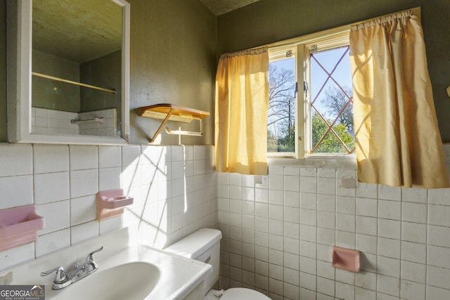 bathroom featuring sink, a wealth of natural light, and toilet