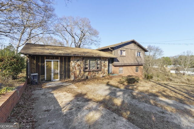 back of property with a sunroom