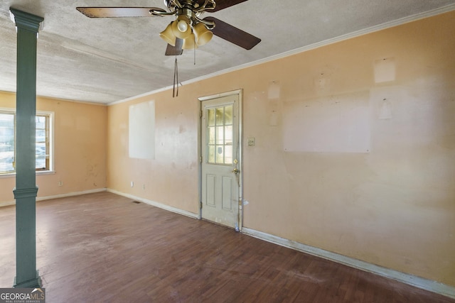 interior space featuring wood-type flooring, a textured ceiling, ornamental molding, ceiling fan, and decorative columns