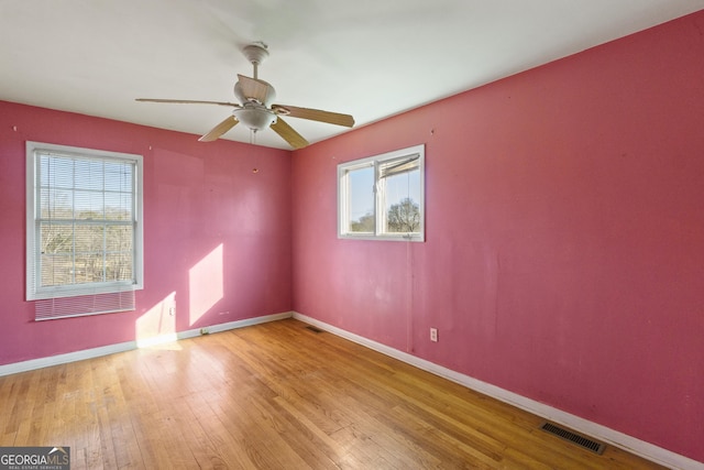 unfurnished room featuring ceiling fan, light wood-type flooring, and a wealth of natural light