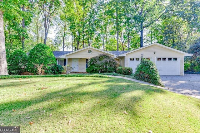 ranch-style home with an attached garage, driveway, and a front yard