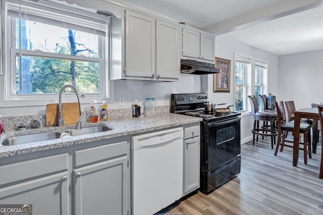 kitchen featuring sink, black electric range, a textured ceiling, dishwasher, and light hardwood / wood-style floors