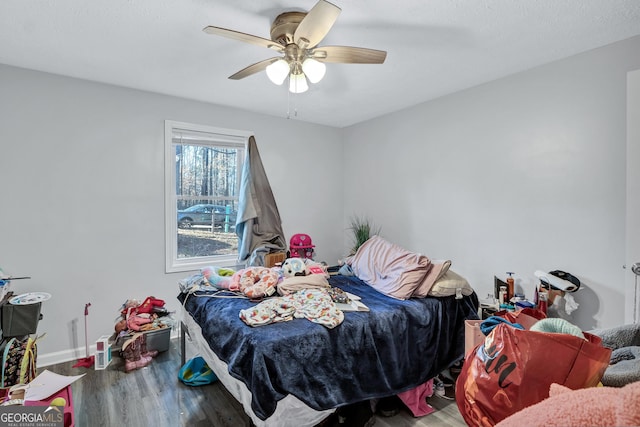 bedroom featuring hardwood / wood-style floors and ceiling fan