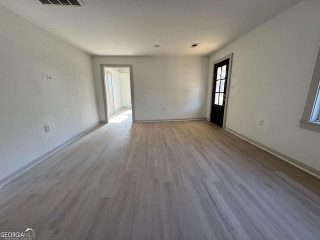 spare room featuring light hardwood / wood-style floors