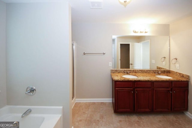 bathroom with vanity and separate shower and tub