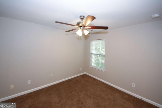 spare room with ceiling fan and carpet