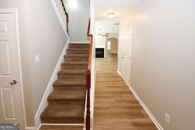 stairs featuring hardwood / wood-style floors