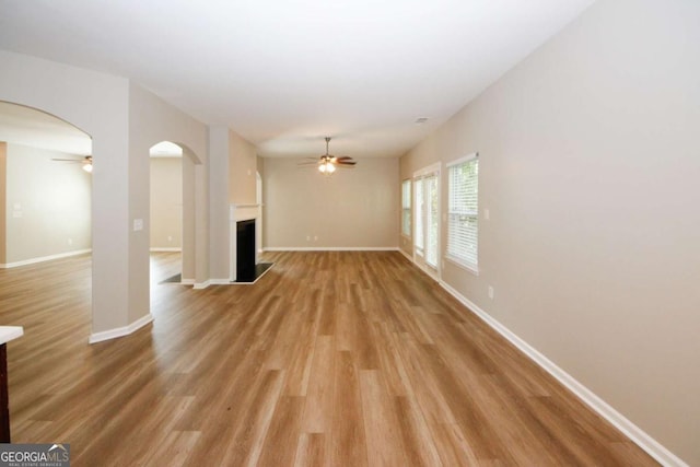 unfurnished living room with ceiling fan and light wood-type flooring